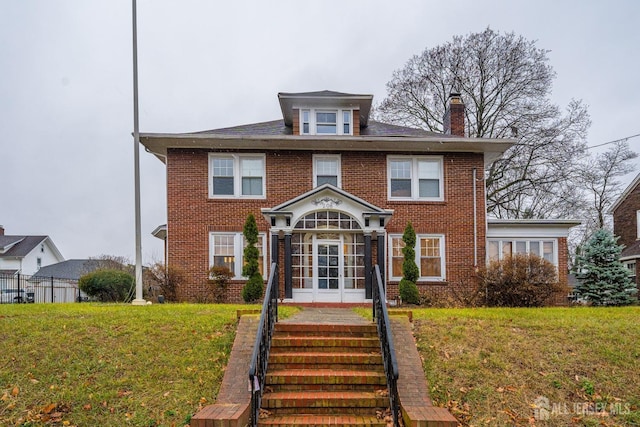 view of front of property featuring a front yard and french doors