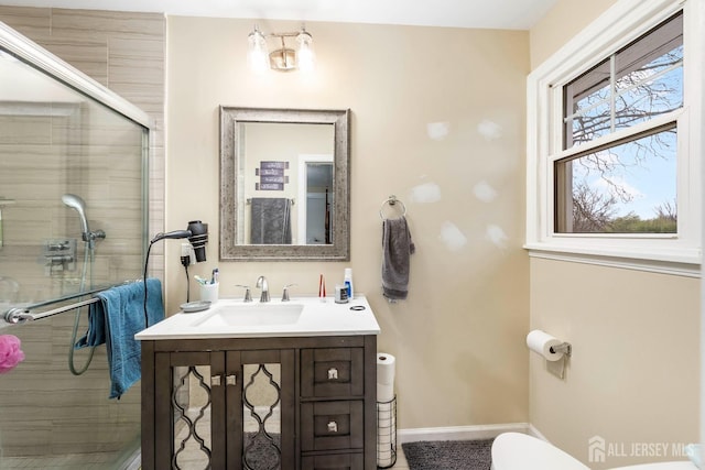 bathroom featuring toilet, vanity, and an enclosed shower