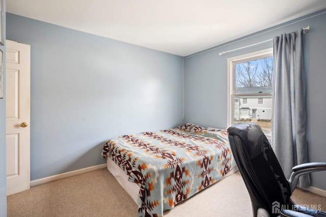 carpeted bedroom featuring baseboards