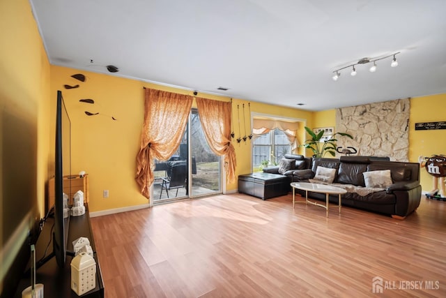 living area with wood finished floors and baseboards