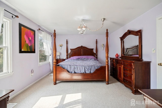 bedroom with baseboards, carpet, and an inviting chandelier