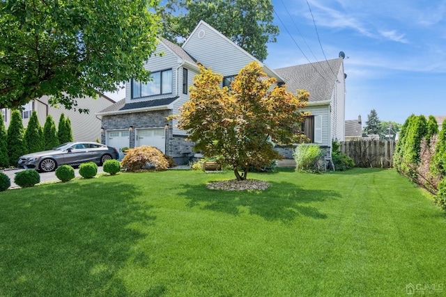 view of front of house with a garage and a front yard