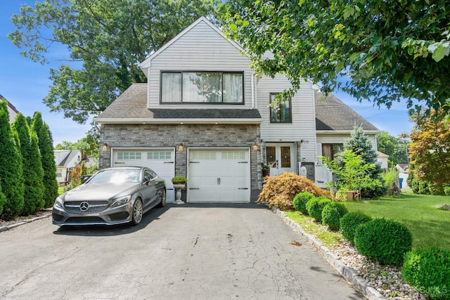 view of front of home with a front lawn and a garage