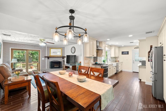 13 Orchard Pkwy, Morganville, NJ 07751 - dining space featuring dark wood-style floors, ceiling fan, a fireplace, healthy amount of natural light, and recessed lighting