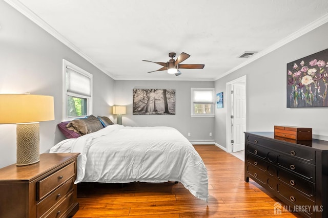 13 Orchard Pkwy, Morganville, NJ 07751 - bedroom with a baseboard heating unit, wood-type flooring, ornamental molding, a ceiling fan, and baseboards