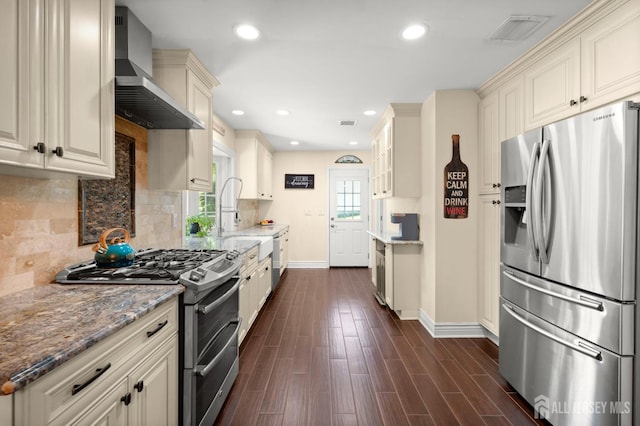13 Orchard Pkwy, Morganville, NJ 07751 - kitchen with appliances with stainless steel finishes, wall chimney exhaust hood, baseboards, light stone countertops, and recessed lighting