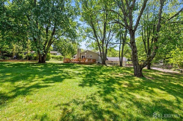 13 Orchard Pkwy, Morganville, NJ 07751 - view of green lawn featuring a deck