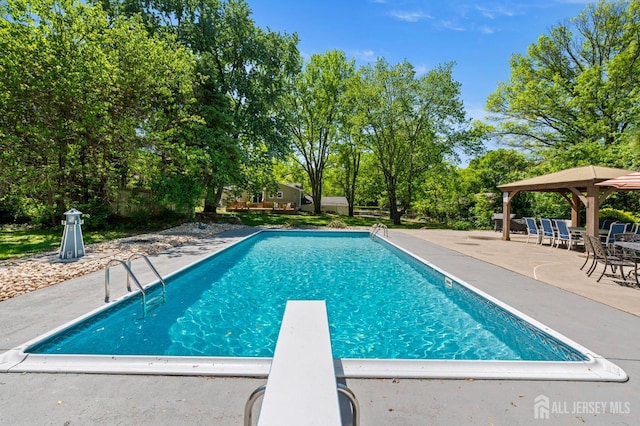13 Orchard Pkwy, Morganville, NJ 07751 - swimming pool with a gazebo, a patio, a diving board, and view of scattered trees