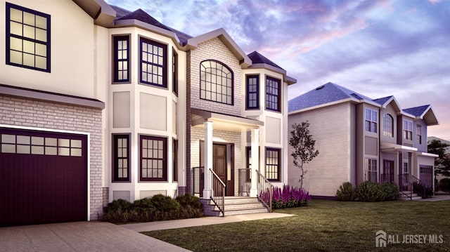 view of front facade with concrete driveway, a garage, and a front yard