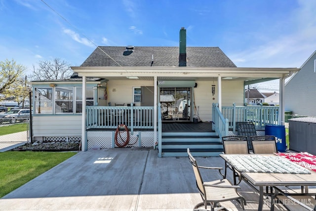 750 Barry Ave, Perth Amboy, NJ 08861 - rear view of house featuring a porch, a sunroom, and roof with shingles