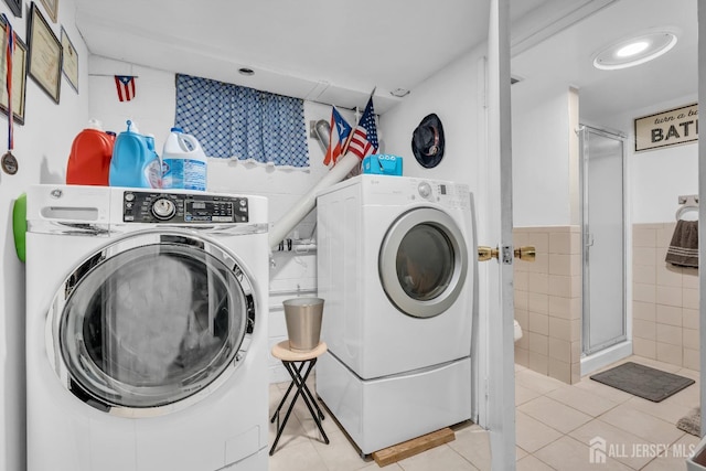 750 Barry Ave, Perth Amboy, NJ 08861 - washroom with recessed lighting, laundry area, washer and clothes dryer, light tile patterned floors, and tile walls