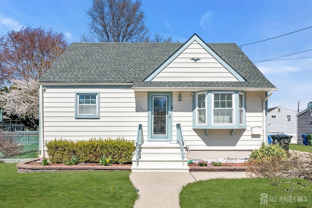750 Barry Ave, Perth Amboy, NJ 08861 - bungalow featuring fence, a front yard, and a shingled roof