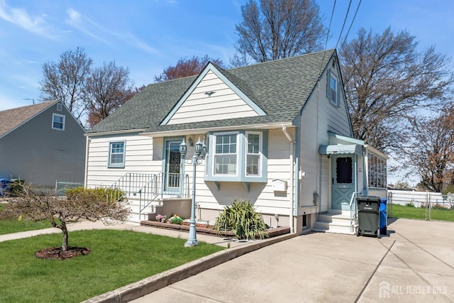 750 Barry Ave, Perth Amboy, NJ 08861 - bungalow-style home with fence, a front lawn, and roof with shingles