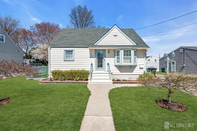 750 Barry Ave, Perth Amboy, NJ 08861 - bungalow featuring a front yard and roof with shingles