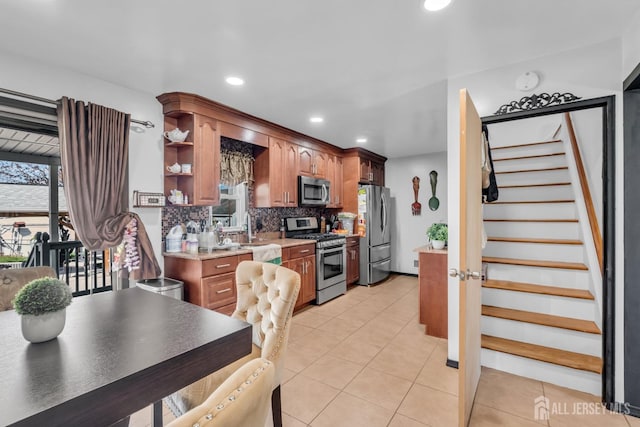 750 Barry Ave, Perth Amboy, NJ 08861 - kitchen featuring a healthy amount of sunlight, appliances with stainless steel finishes, decorative backsplash, and light tile patterned floors