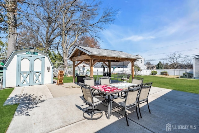 750 Barry Ave, Perth Amboy, NJ 08861 - view of patio featuring a gazebo, a storage shed, outdoor dining space, a fenced backyard, and an outbuilding