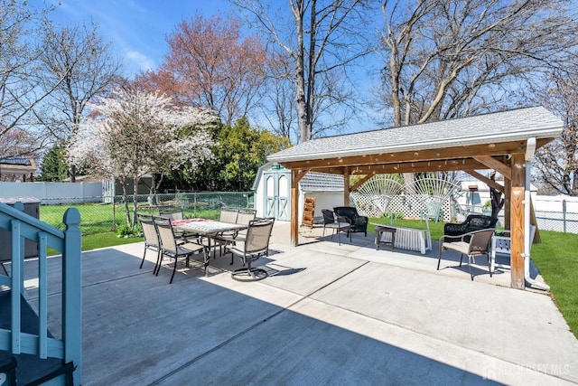 750 Barry Ave, Perth Amboy, NJ 08861 - view of patio with an outdoor structure, a fenced backyard, a storage shed, outdoor dining space, and a gazebo