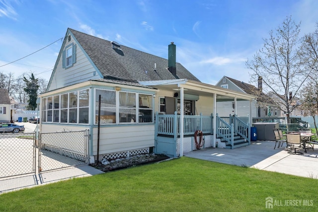 750 Barry Ave, Perth Amboy, NJ 08861 - rear view of house with a patio, a gate, a shingled roof, a lawn, and fence