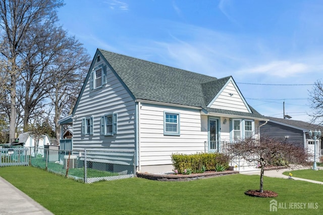 750 Barry Ave, Perth Amboy, NJ 08861 - view of front of home with fence, roof with shingles, and a front yard