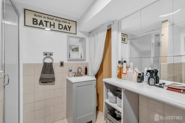 750 Barry Ave, Perth Amboy, NJ 08861 - full bathroom featuring a shower with shower door, tile walls, and vanity
