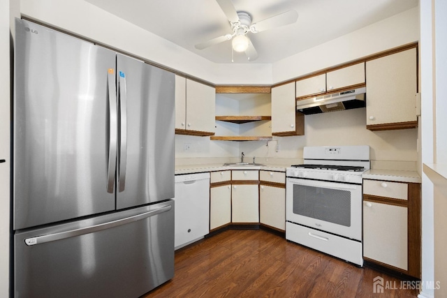 kitchen featuring white appliances, light countertops, under cabinet range hood, open shelves, and a sink