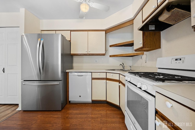 kitchen with light countertops, white appliances, a sink, and under cabinet range hood