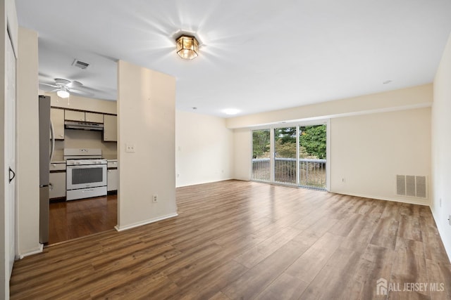 unfurnished living room with ceiling fan and hardwood / wood-style floors