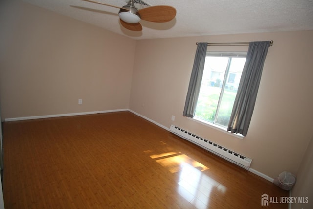 236-A Vernon Rd, Monroe, NJ 08831 - unfurnished room with a baseboard heating unit, ceiling fan, and wood finished floors