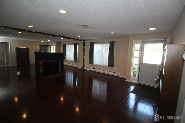 236-A Vernon Rd, Monroe, NJ 08831 - unfurnished living room with baseboard heating, a textured ceiling, recessed lighting, wood finished floors, and a fireplace