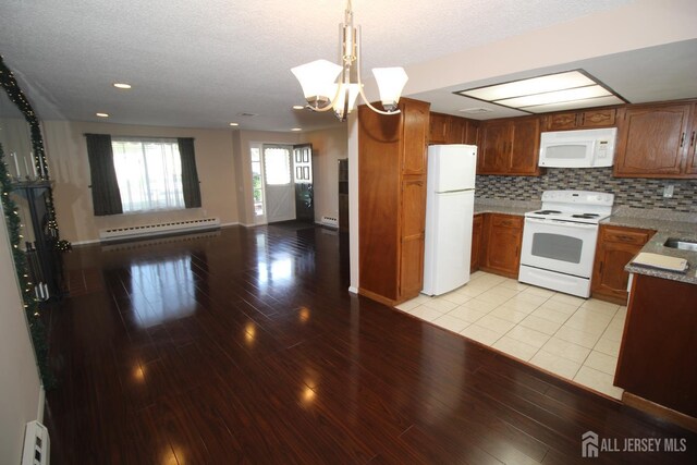 236-A Vernon Rd, Monroe, NJ 08831 - kitchen with white appliances, a baseboard heating unit, light wood-style flooring, open floor plan, and a chandelier