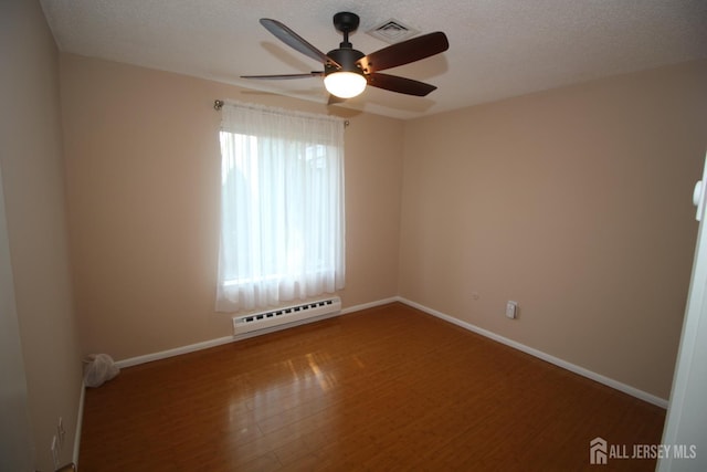 236-A Vernon Rd, Monroe, NJ 08831 - spare room with a baseboard heating unit, wood finished floors, ceiling fan, and a textured ceiling