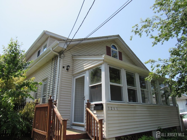 1211 S 9th St, South Plainfield, NJ 07080 - view of property exterior featuring a sunroom