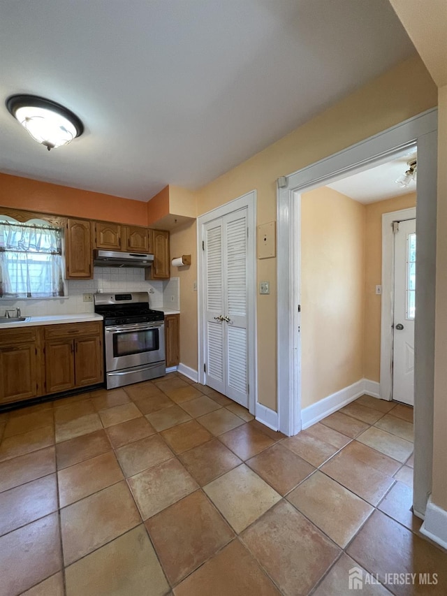 1211 S 9th St, South Plainfield, NJ 07080 - kitchen with stainless steel range with gas cooktop, under cabinet range hood, light countertops, and baseboards