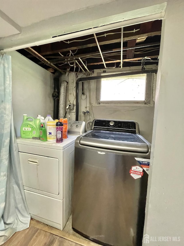 1211 S 9th St, South Plainfield, NJ 07080 - laundry area with washing machine and clothes dryer and light wood-style floors