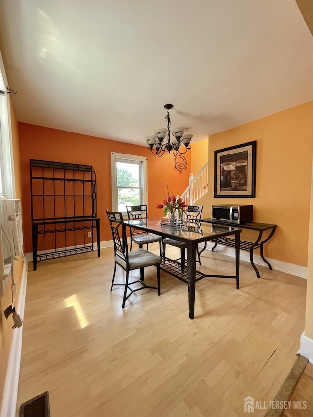 1211 S 9th St, South Plainfield, NJ 07080 - dining space with a chandelier, baseboards, and light wood-style flooring