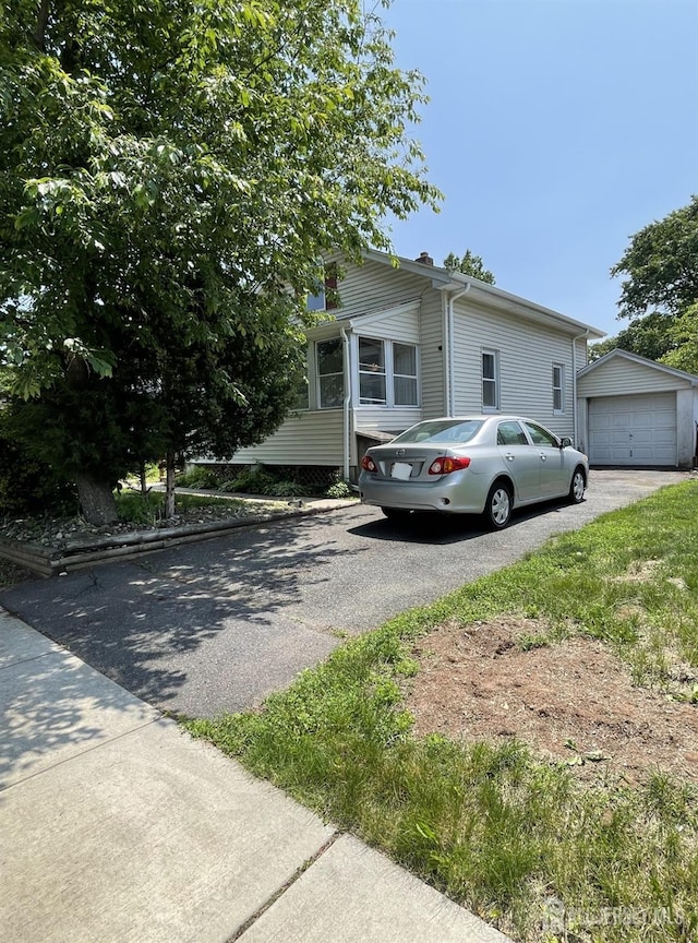 1211 S 9th St, South Plainfield, NJ 07080 - view of front of property with driveway, an outdoor structure, a chimney, and a garage