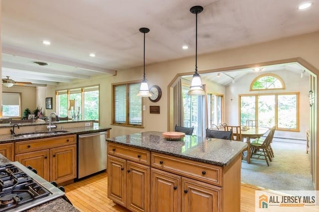 57 Jensen St, East Brunswick, NJ 08816 - kitchen with appliances with stainless steel finishes, brown cabinetry, recessed lighting, dark stone countertops, and light wood-style floors