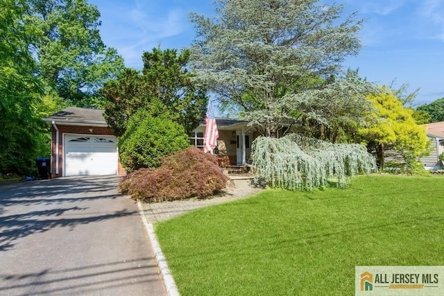 57 Jensen St, East Brunswick, NJ 08816 - view of property hidden behind natural elements with asphalt driveway, a front lawn, an attached garage, and brick siding