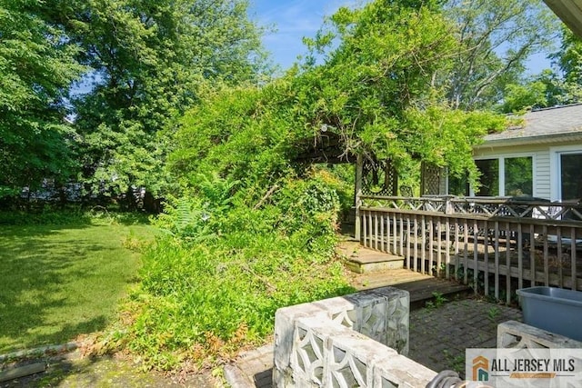 57 Jensen St, East Brunswick, NJ 08816 - view of grassy yard featuring a deck