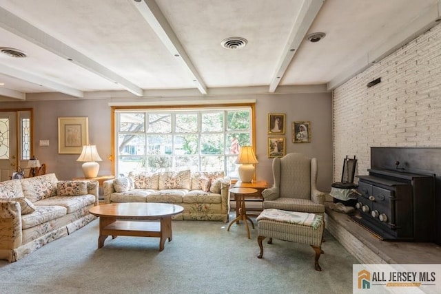 57 Jensen St, East Brunswick, NJ 08816 - living area with carpet flooring, beamed ceiling, and a wood stove