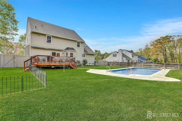 rear view of property featuring a wooden deck and a gate