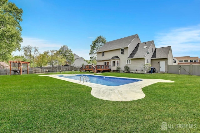 view of swimming pool with a wooden deck and a gate