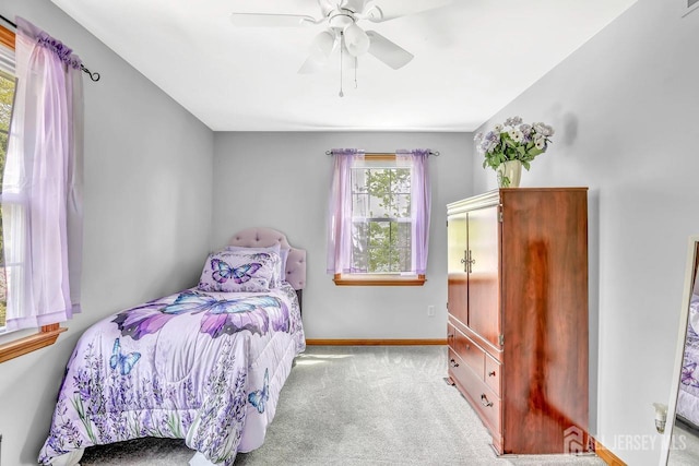 carpeted bedroom with baseboards and ceiling fan