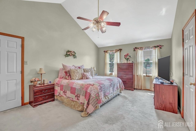 bedroom with light carpet, high vaulted ceiling, a ceiling fan, and baseboards