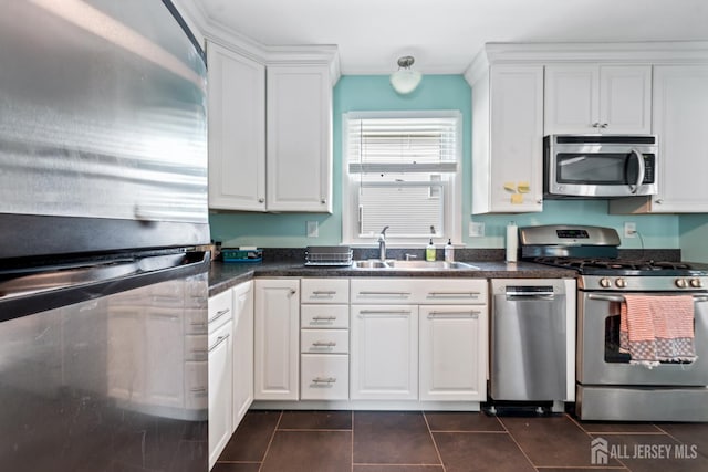 1775 W 5th St, Piscataway, NJ 08854 - kitchen featuring stainless steel appliances, white cabinetry, dark tile patterned floors, and dark countertops