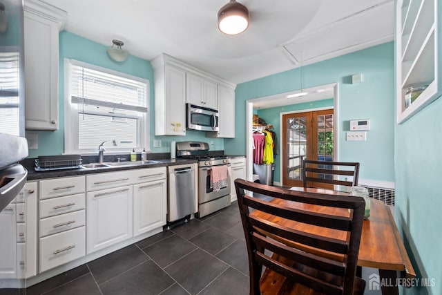 1775 W 5th St, Piscataway, NJ 08854 - kitchen with stainless steel appliances, dark countertops, white cabinetry, and dark tile patterned floors