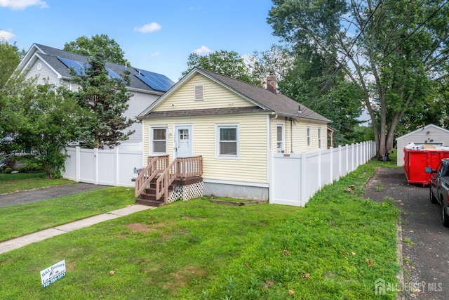 1775 W 5th St, Piscataway, NJ 08854 - view of front of property with roof with shingles, asphalt driveway, a chimney, and a garage