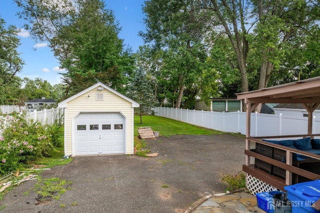 1775 W 5th St, Piscataway, NJ 08854 - detached garage with driveway and view of scattered trees