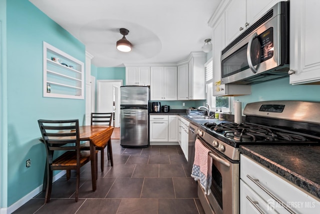 1775 W 5th St, Piscataway, NJ 08854 - kitchen with appliances with stainless steel finishes, dark countertops, and white cabinetry