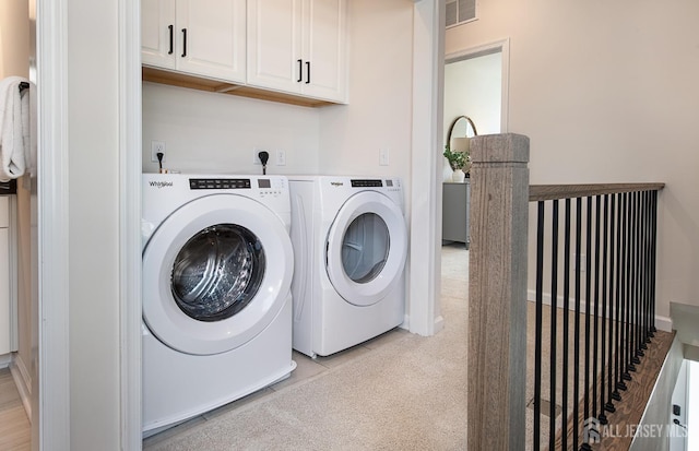clothes washing area with washing machine and clothes dryer, visible vents, and light tile patterned floors